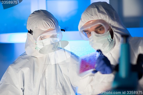 Image of close up of scientists making test in chemical lab