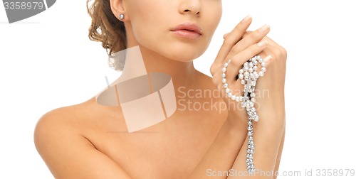 Image of woman with pearl earrings and necklace