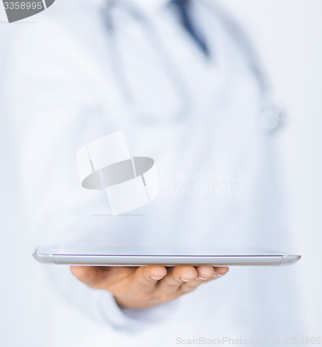 Image of male doctor holding tablet pc