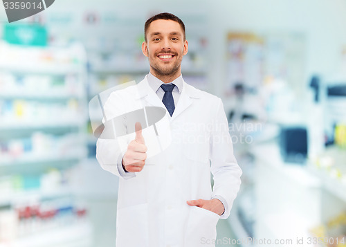 Image of smiling pharmacist showing thumbs up at drugstore