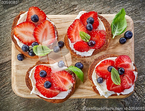 Image of toasted bread with berries and cream cheese