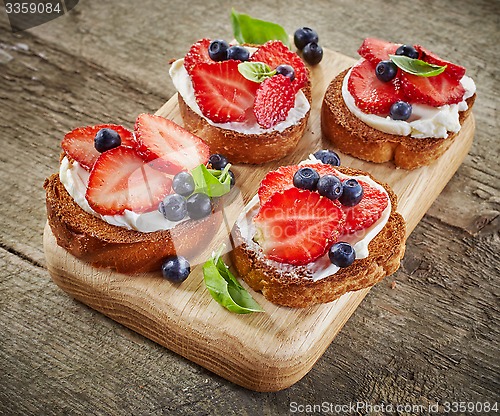 Image of toasted bread with berries and cream cheese