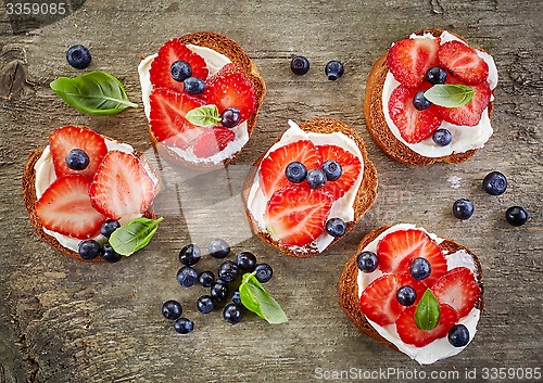 Image of toasted bread with berries and cream cheese