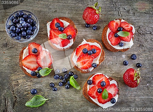 Image of toasted bread with berries and cream cheese