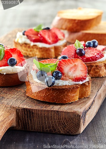 Image of toasted bread with berries and cream cheese