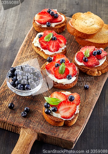 Image of toasted bread with berries and cream cheese