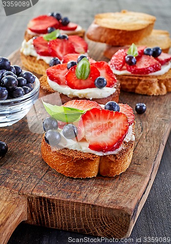 Image of toasted bread with berries and cream cheese