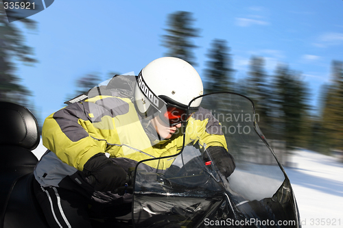 Image of Teen boy on snowmobile