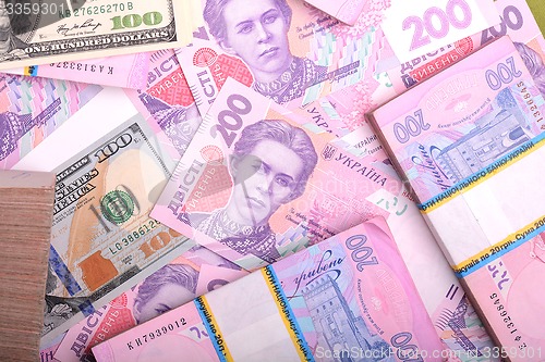 Image of american money dollars, ukrainian money hryvnia, financial backg