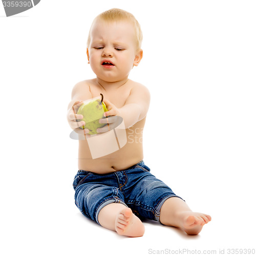 Image of dissatisfied boy disclaims pears on a white background