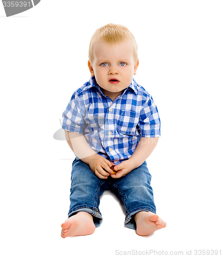 Image of little boy in a plaid shirt and jeans