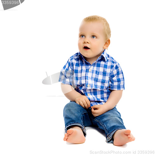 Image of little boy in a plaid shirt and jeans