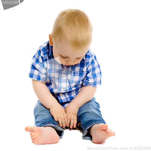 Image of little boy in a plaid shirt and jeans