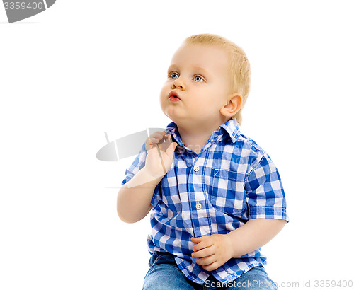 Image of little boy in a plaid shirt and jeans