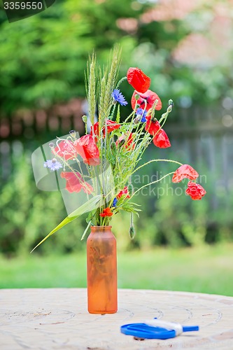 Image of Bunch of of red poppies and cornflowers