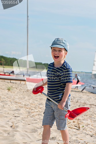 Image of Young boy playing with sand