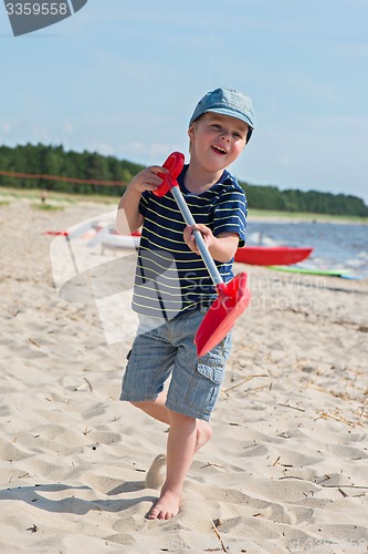Image of Young boy playing with sand