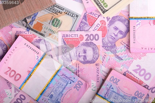Image of american money dollars, ukrainian money hryvnia, financial backg