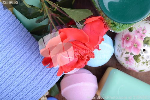 Image of Spa and wellness setting with sea salt, soap, flowers and towels on wooden background. Relax and treatment therapy. Summer season. Close upq