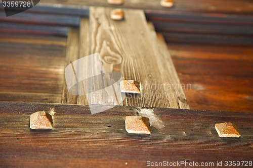 Image of red abstract  house door    in italy       closed nail rusty