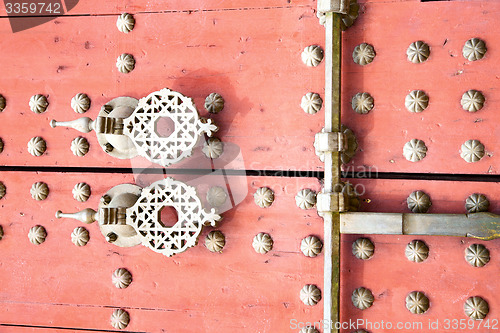 Image of rusty  brown    morocco in red  safe padlock 