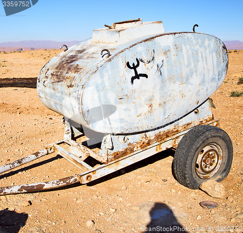 Image of water tank in morocco africa land gray  metal weel and arid