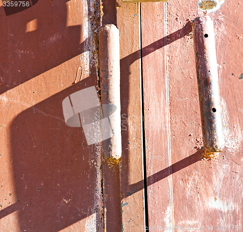 Image of metal rusty  brown    morocco in red  wood   safe padlock 