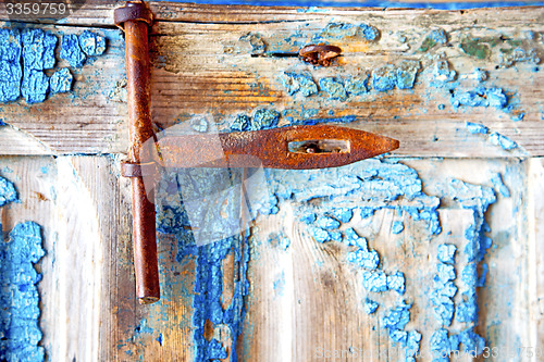 Image of rusty metal    dirty stripped paint in the   morocco knocker