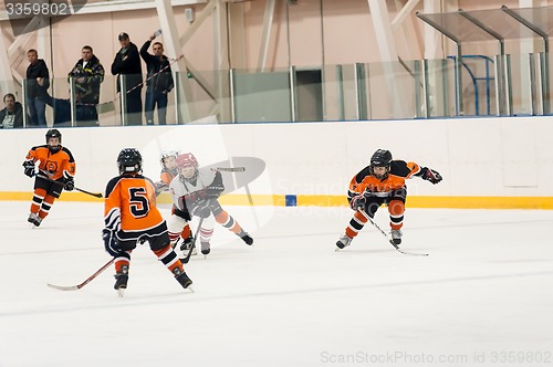 Image of Game between children ice-hockey teams