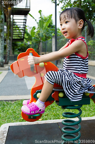 Image of Asian Kid Riding at Park