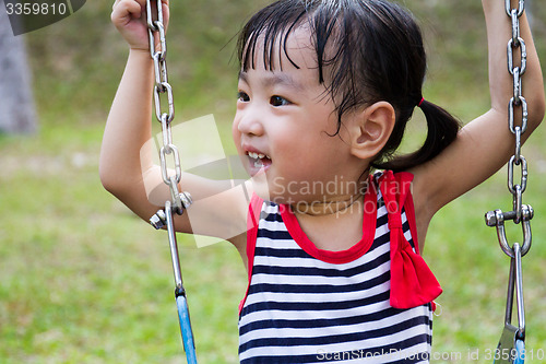 Image of Asian Kid Swing At Park