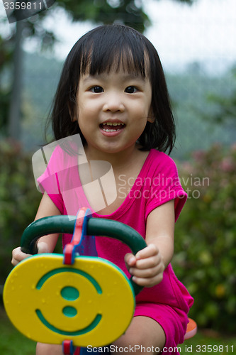 Image of Asian Kid Riding at Park