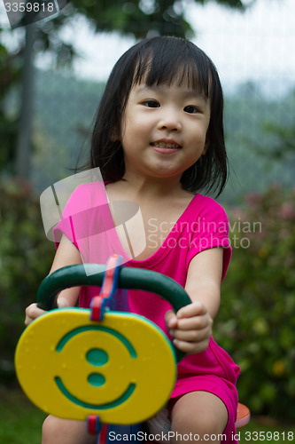 Image of Asian Kid Riding at Park