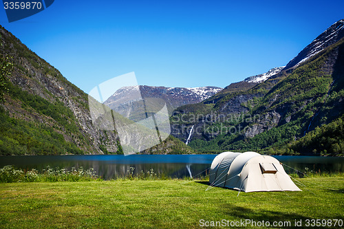 Image of Tourist tent on the shore of the lake.