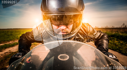 Image of Biker racing on the road