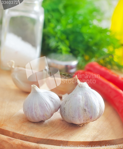 Image of Fresh garlic and aroma spice on the wooden board