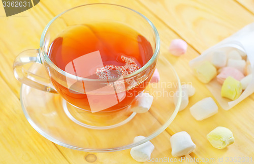 Image of Fresh tea with candy