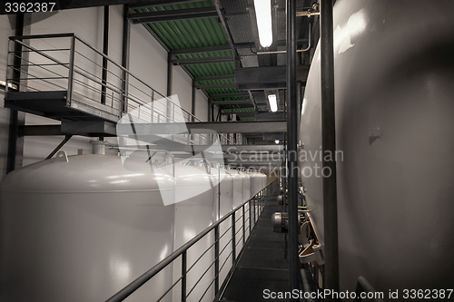 Image of Large industrial white silos in modern factory