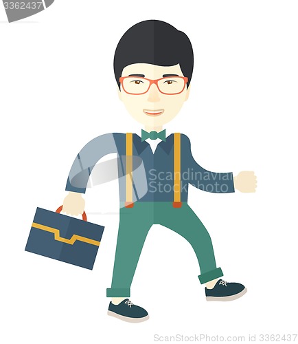 Image of Young asian man walking with his briefcase.