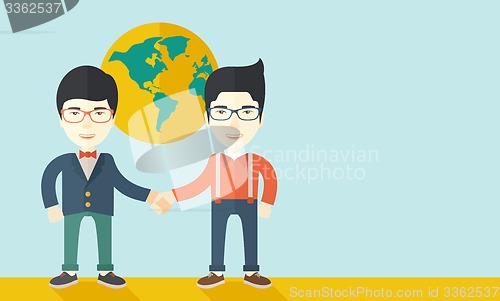 Image of Two chinese guys happily handshaking.