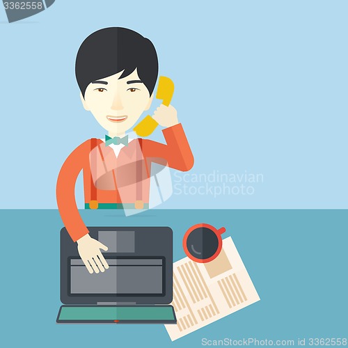 Image of Chinese office man sitting at his working desk. 
