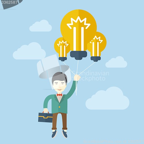 Image of Asian businessman carrying a briefcase with bulb.