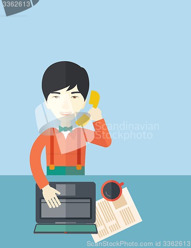 Image of Chinese office man sitting at his working desk. 