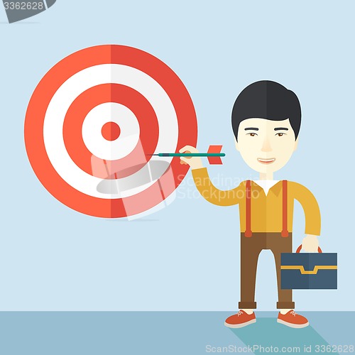 Image of Working chinese man holding a target arrow 