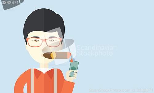 Image of Asian Businessman lighting the cigar tobacco.