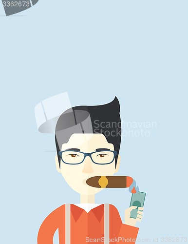 Image of Asian Businessman lighting the cigar tobacco.