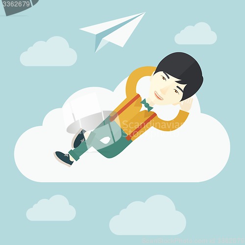 Image of Asian man lying on a cloud with paper plane.