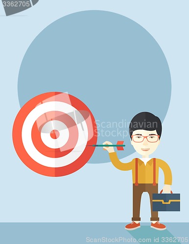 Image of Working chinese man holding a target arrow 