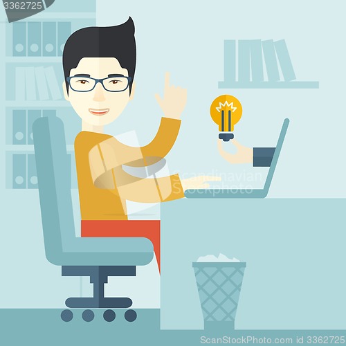 Image of Asian guy working inside his office.