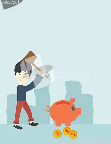 Image of Chinese guy holding a hammer breaking piggy bank.